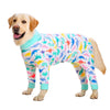 A golden Labrador wearing a colorful cartoon print cotton pajama coat.