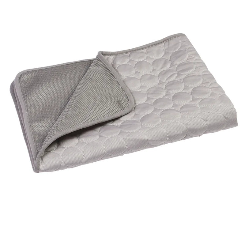 A gray cooling pet mat for dogs and cats, folded and displayed on a white background.