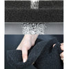 A hand is squeezing a black, porous sponge filter used for biochemical aquarium filtration.