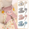 A collection of pink, gray, and blue pet leash harnesses for dogs and cats displayed on a fluffy garment.