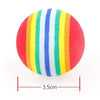 A spherical catnip chew toy with vertical stripes of red, orange, yellow, green, blue, and white.