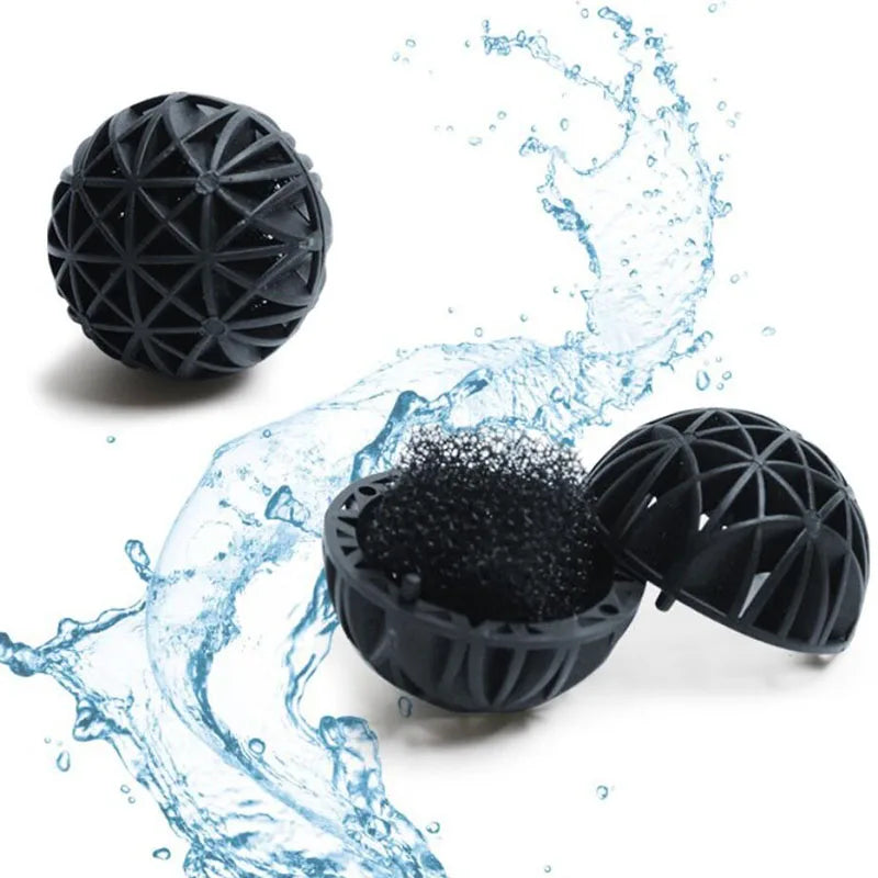 Black aquarium bio balls being washed in water, showing their porous structure and filtration capability.