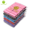 A stack of 14 rolls of pink, blue, and purple paw print dog waste bags with a dispenser.