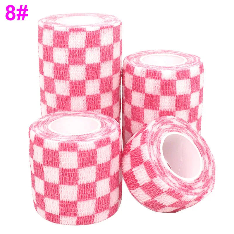 Rolls of pink checkered printed self-adhesive elastic bandage tape