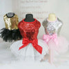 Three sequined princess dog dresses displayed on mannequins with a quote about love.