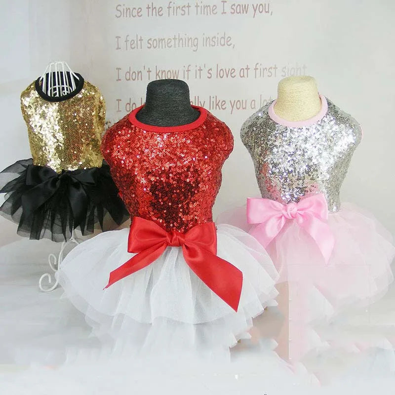 Three sequined princess dog dresses displayed on mannequins with a quote about love.