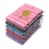 A stack of pink, blue, and red paw print dog waste bags with a dispenser.