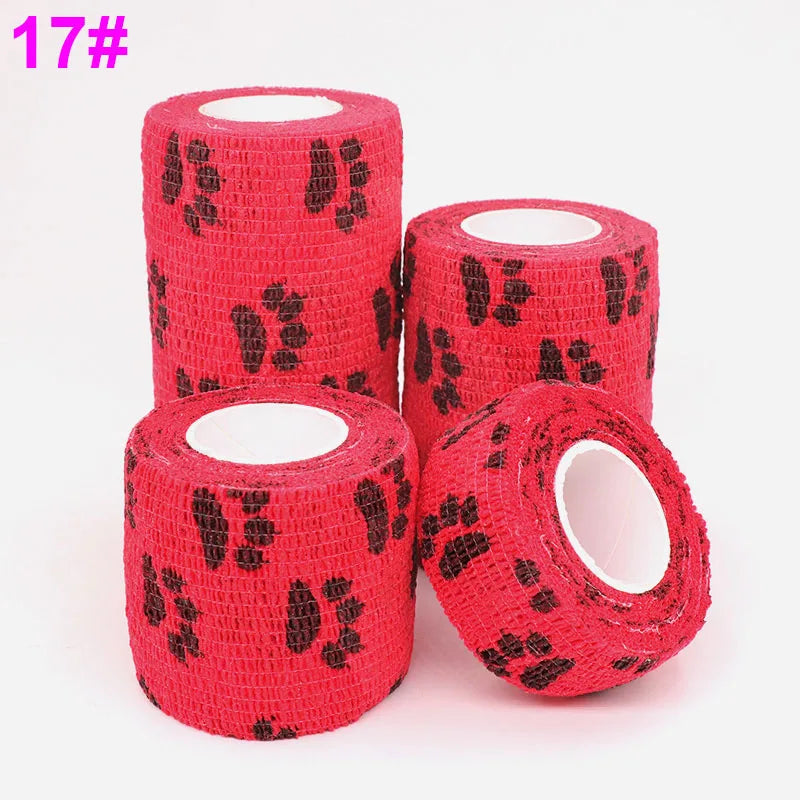 Three rolls of red knitted elastic bandage tape with black paw print pattern