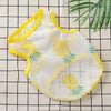 A yellow and white breathable mesh vest for small dogs or cats lying on a checkered surface.