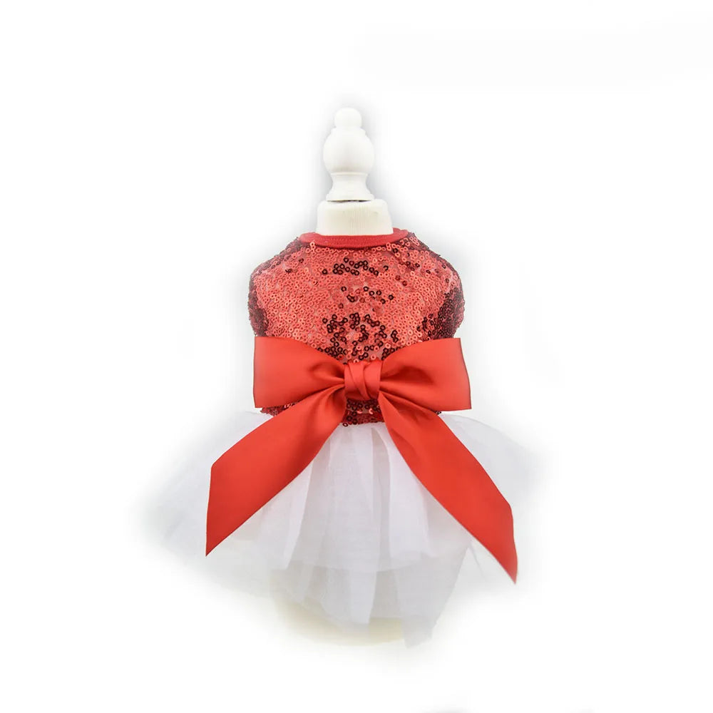 A red sequined princess dog dress with a bow and white tulle skirt displayed on a mannequin.