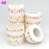 Rolls of printed self-adhesive elastic bandage tape in white with multi-colored star patterns
