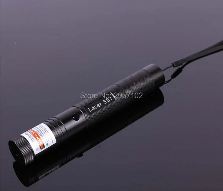 A black portable laser indicator light device is shown against a dark background.