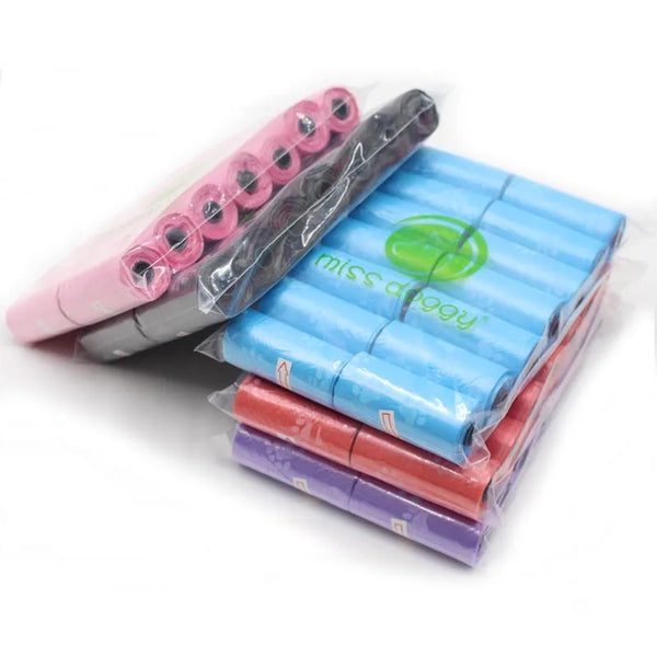 A pack of 14 rolls of pink, blue, and red paw print dog waste bags with a dispenser.