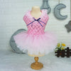 A pink sequined princess dress for a puppy displayed on a mannequin against a white tiled wall.