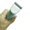 A hand holds a light green pet grooming trimmer with a silver comb attachment.