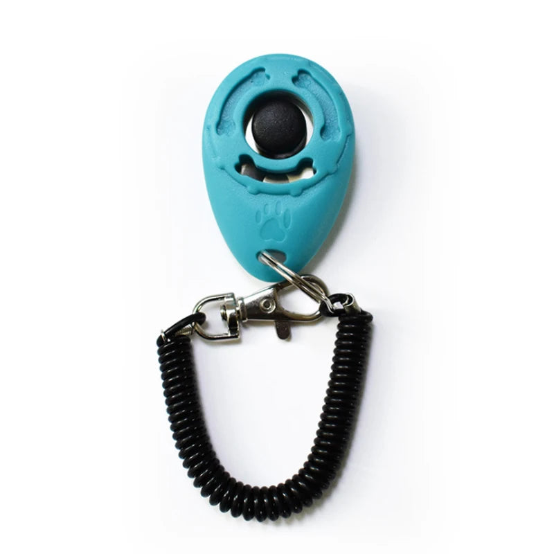 A teal pet training clicker with a black eye and a black nylon wrist strap.