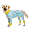 A golden retriever wearing a light blue cartoon print cotton pajama coat.