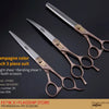 A set of champagne color straight and bending shear scissors for professional pet grooming.