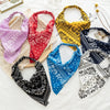 A collection of colorful bohemian paisley triangle head scarves in various patterns and fabrics.