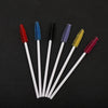 A collection of seven disposable eyelash brushes in various colors including red, blue, black, purple, yellow, and pink.