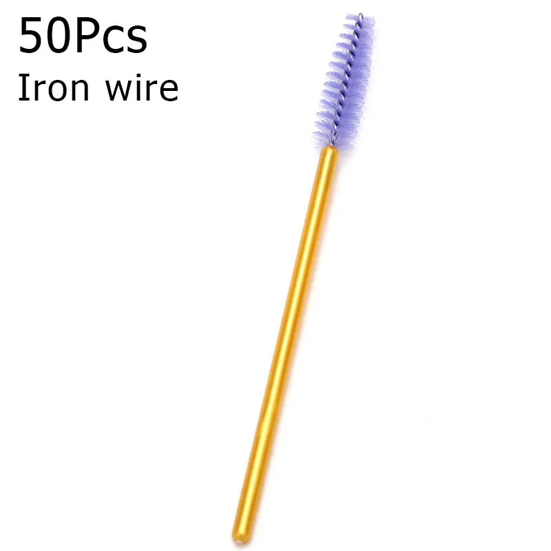 A single golden iron wire eyelash brush with purple bristles shown against a white background.
