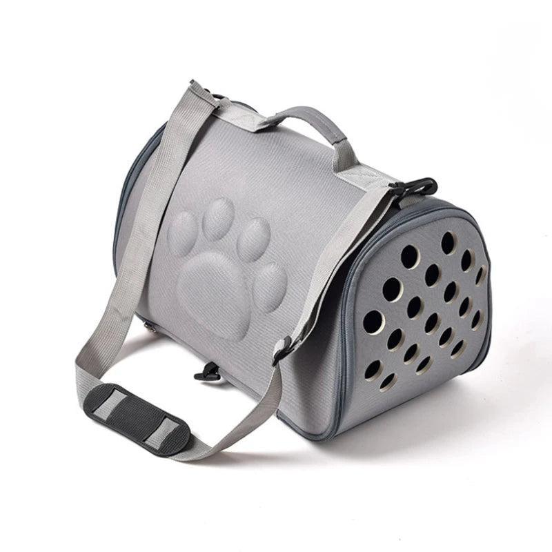 A gray breathable pet carrier bag for cats and small dogs with a handle and mesh ventilation holes.