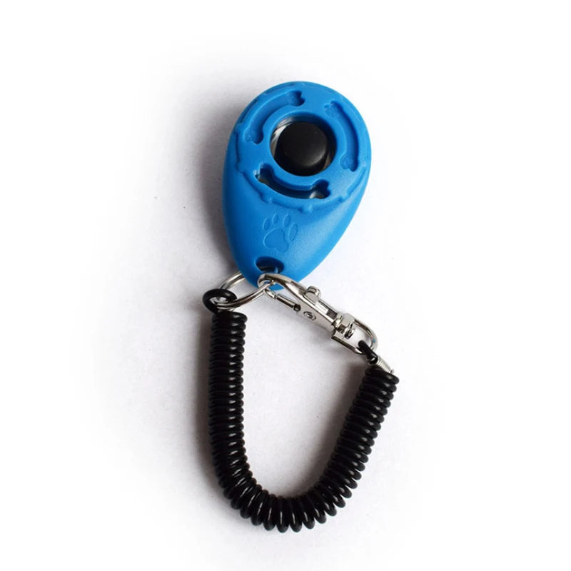 Blue pet training clicker with a black tip attached to a black nylon wrist strap.