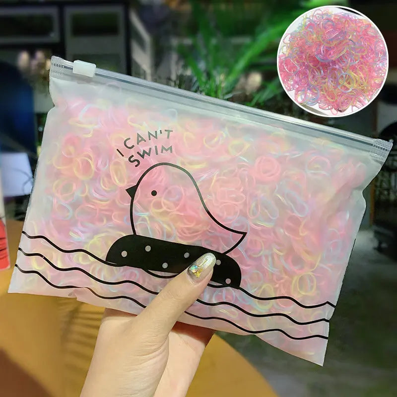 A clear plastic bag filled with pink and yellow elastic hair bands, featuring a silhouette of a duck swimming in water.