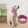 A light-colored dog is wearing a soft lavender pet ear muff for comfort and noise reduction.