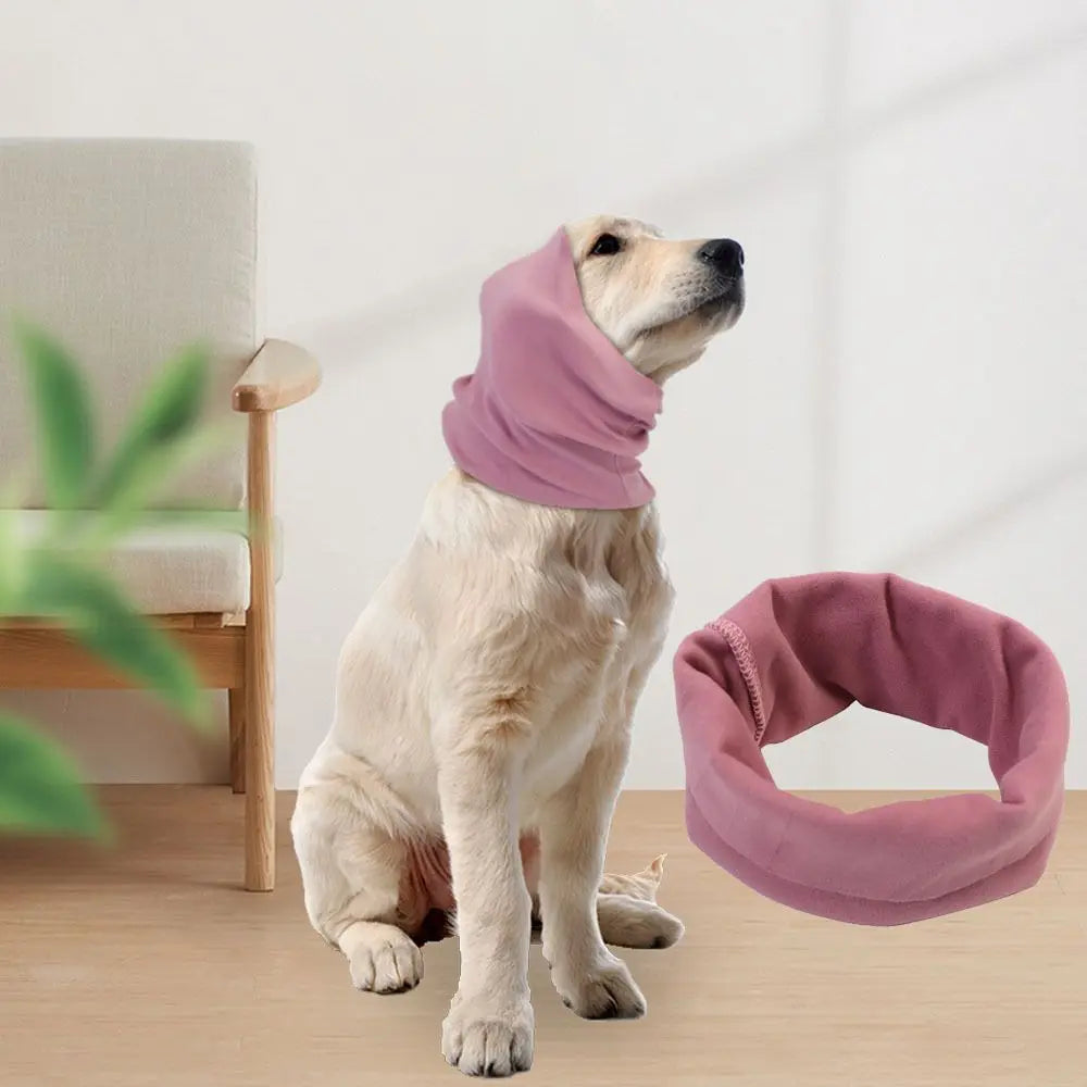 A light-colored dog is wearing a soft lavender pet ear muff for comfort and noise reduction.