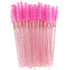 A bundle of pink disposable eyelash brushes with sparkly pink bristles and clear plastic handles.
