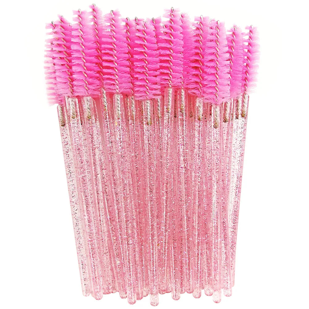 A bundle of pink disposable eyelash brushes with sparkly pink bristles and clear plastic handles.