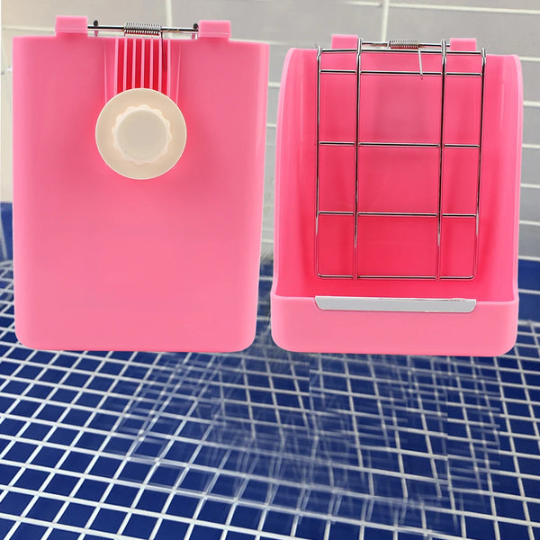 A pink rabbit hay and food rack with a wire grid and a circular opening sits on a blue grid surface.