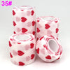 Rolls of pink and red patterned printed self-adhesive elastic bandage tape