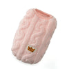 A pink, fluffy fleece pet sweater with a crown-shaped tag.