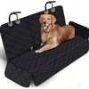 A golden retriever dog is resting on a black quilted waterproof car seat cover with handles.