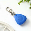 A blue waterproof LED pet collar light tag attached to a metal clasp, resting on a white surface.
