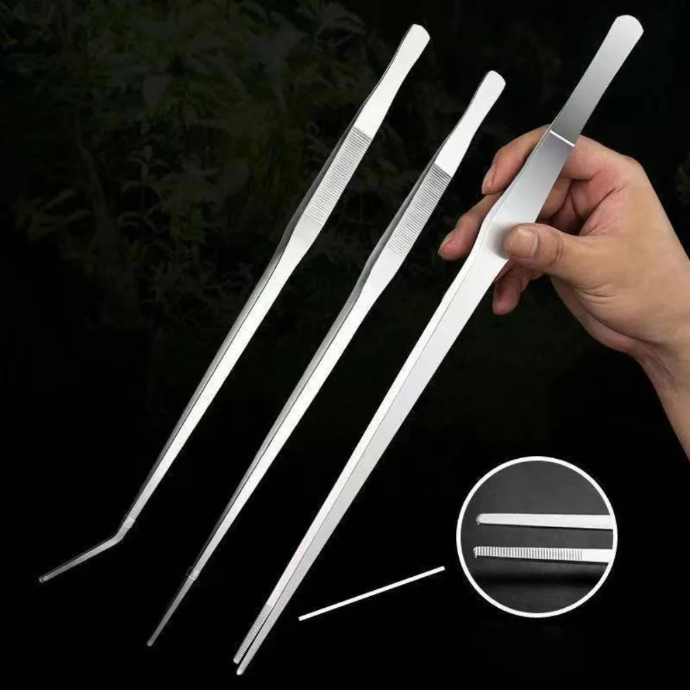 A hand holds a set of stainless steel aquarium plant tweezers, showing various sizes and tips.