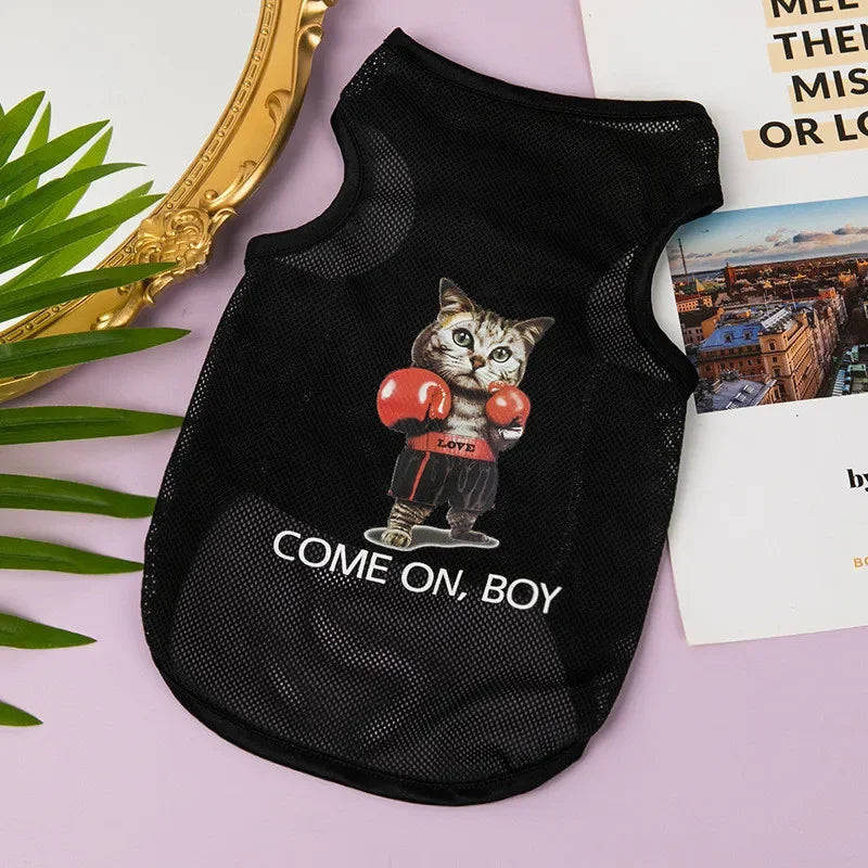 Black breathable mesh pet vest with a cartoon cat boxer design on a light purple background.