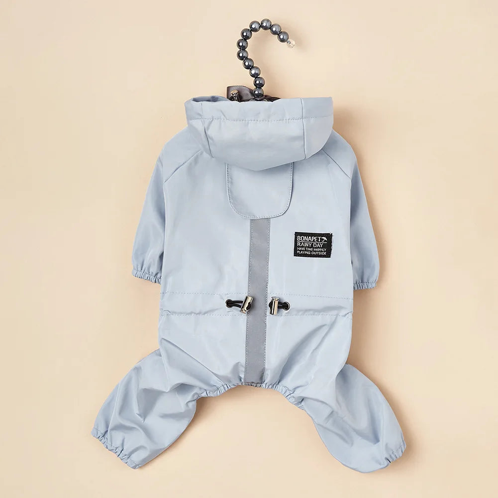Light blue waterproof reflective dog raincoat and jumpsuit hanging on a hook