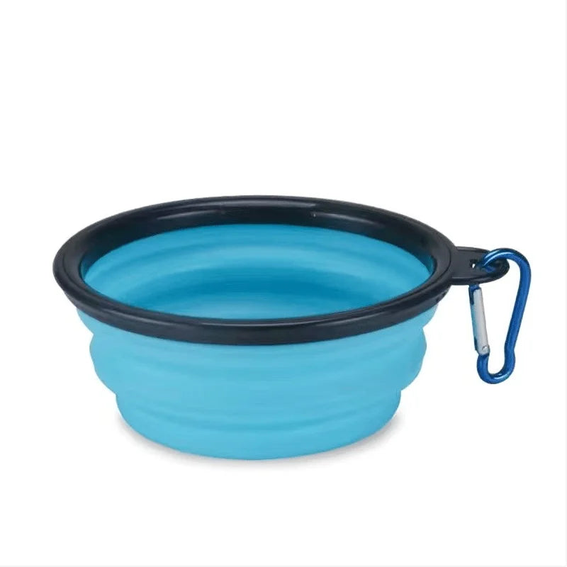 A blue silicone collapsible pet travel bowl with a black rim and a blue strap.