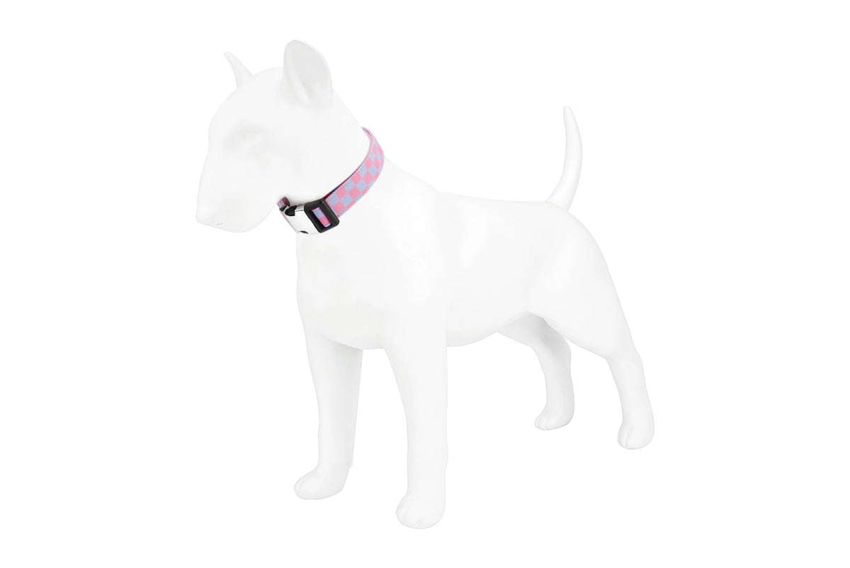 A white dog figure wearing a pink and black checker pattern nylon collar.