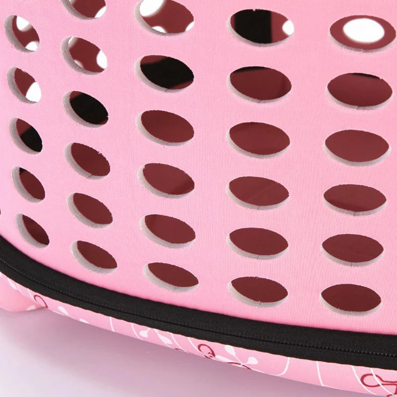 Pink breathable pet carrier backpack with a perforated design for cats and small dogs