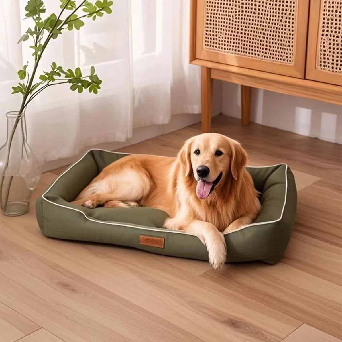 A golden retriever lies comfortably on a green orthopedic dog bed indoors.