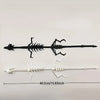 A black articulated dragon skeleton model displayed against a white background.