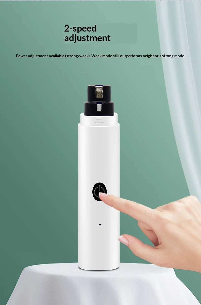 A white quiet rechargeable pet nail grinder bottle with a black cap is shown being operated by a hand.