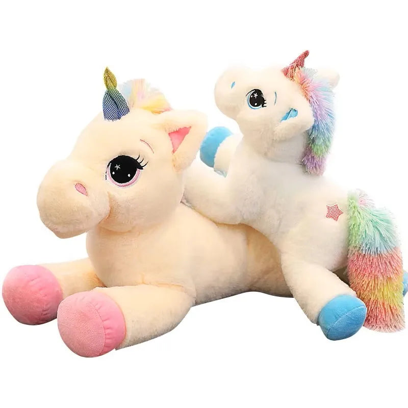 A soft, light yellow unicorn plush toy with rainbow colored mane and tail.