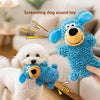 A blue plush screaming dog sound toy is being played with by a white poodle.