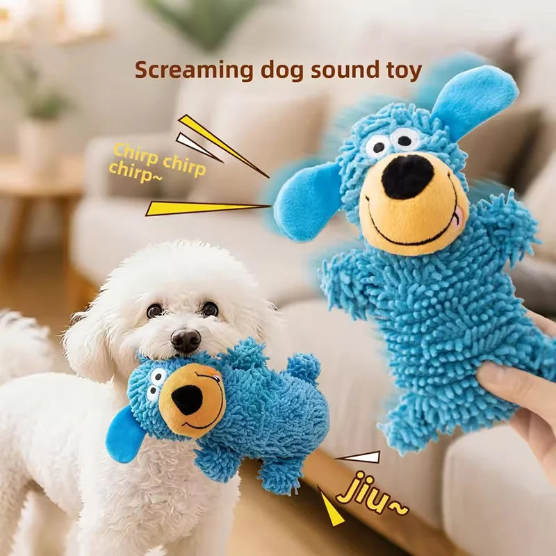 A blue plush screaming dog sound toy is being played with by a white poodle.