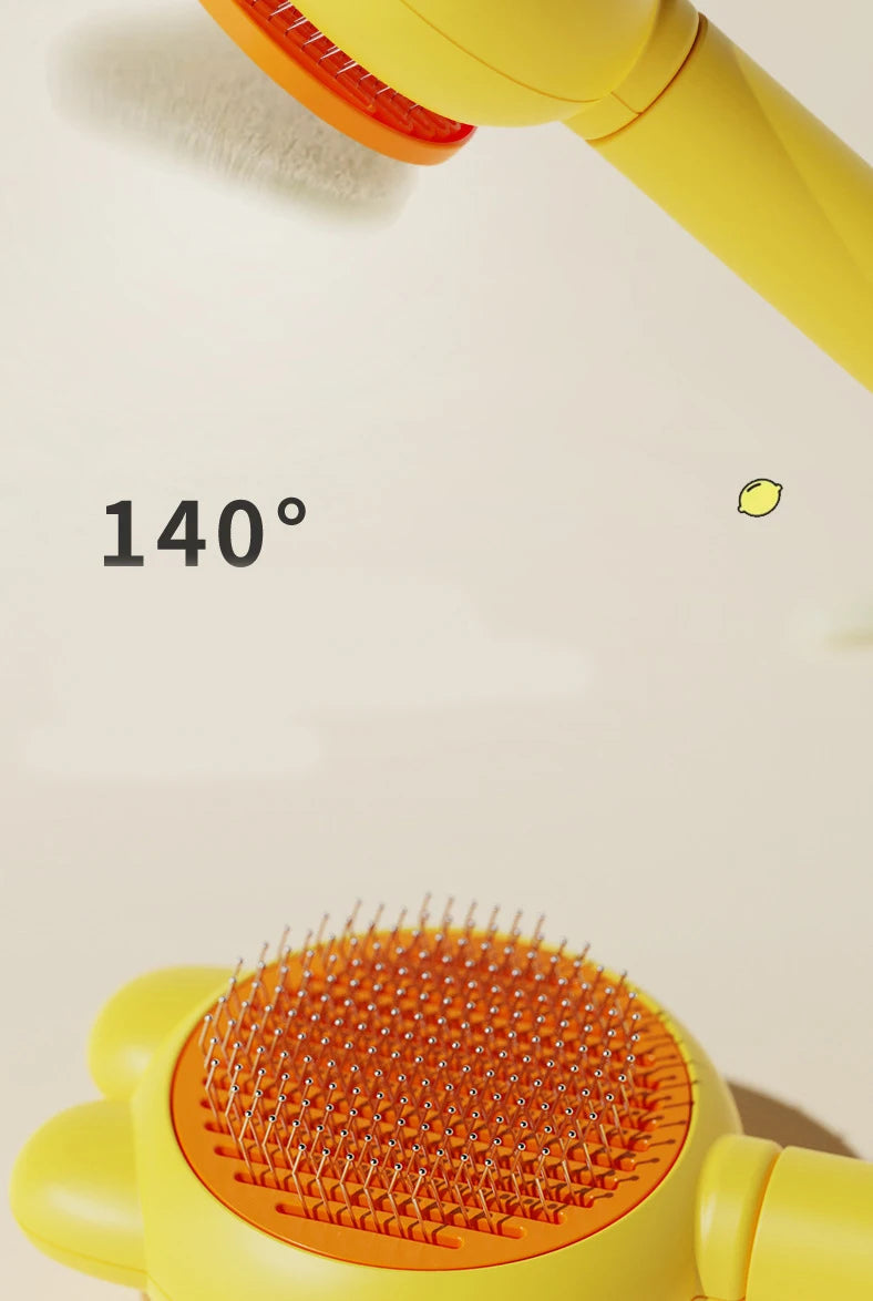 A close-up of a yellow pet deshedding brush with an orange bristled head, showing a 140 degree angle.